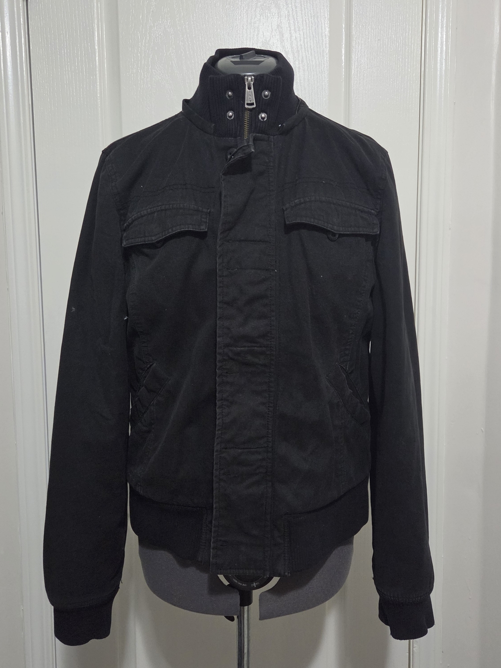 Black TNA jacket with red and black plaid lining